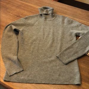 Grey turtle neck sweater.